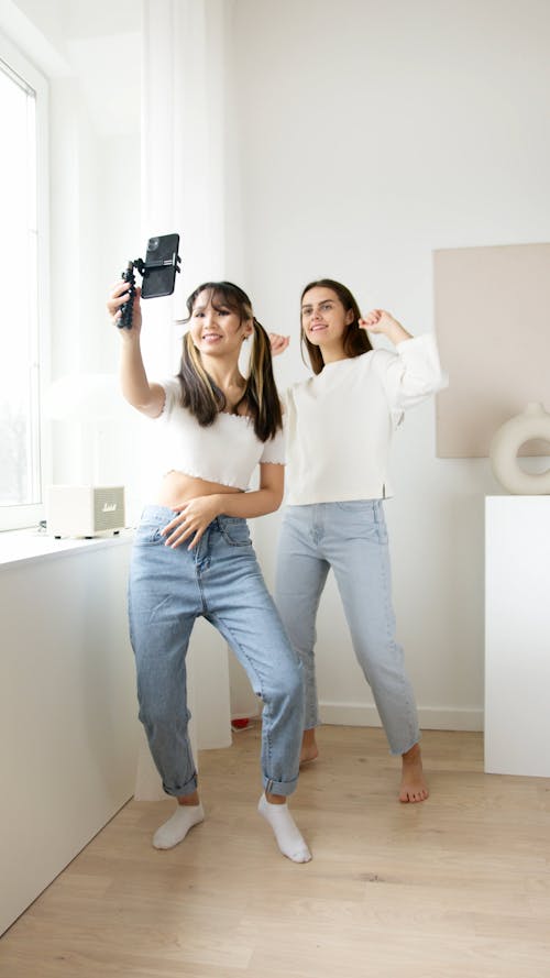 Two Young Women Making A Dance Video