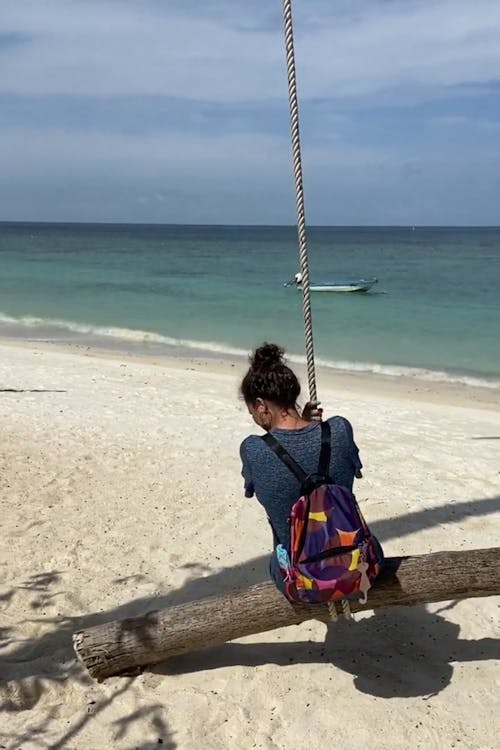 A Woman Swinging on the Beach