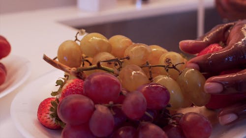 Close-Up View of a Person Washing Fresh Fruits