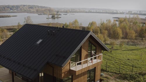 Woman in the Balcony of a Remote House