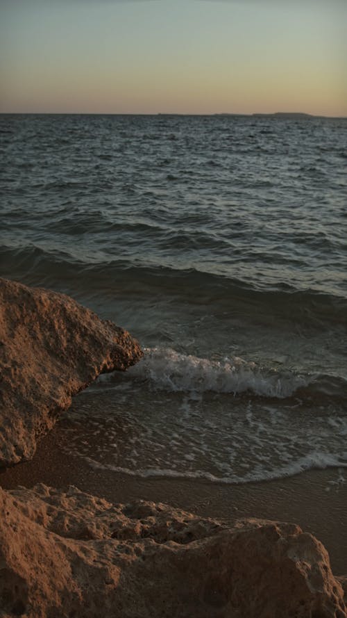 Sea Waves Causing Erosion On The Shore Rocks Formation