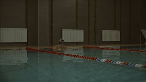 A Man Swimming In The Pool