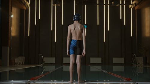 A Boy Diving In The Pool