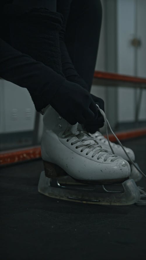 Person Tying Her Ice Skating Shoes