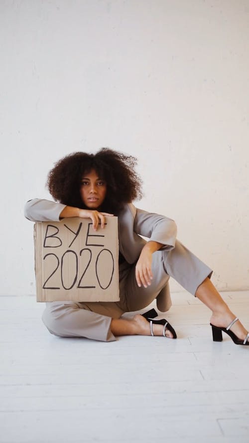 A Woman Holding a Bye 2020 Poster