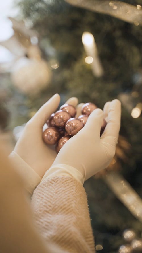 Close Up Video of a Person Holding Christmas Balls