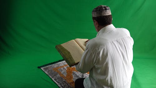 Man on Knees Reading Quran