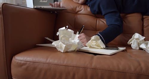 Lonely Woman Writing in Diary on Couch