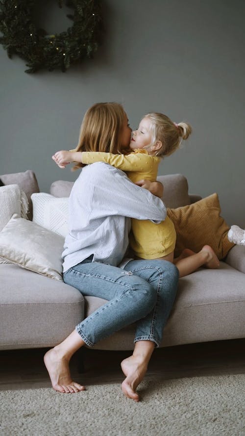 Mother and Daughter Hugging and Kissing Each Other