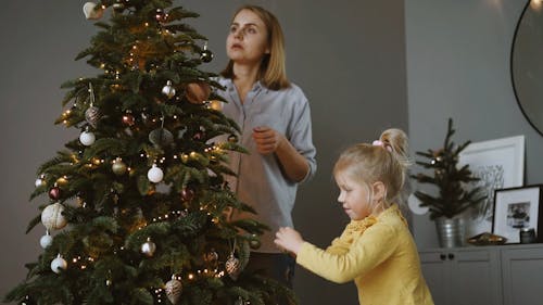 Mother and Daughter Decorating Christmas Tree