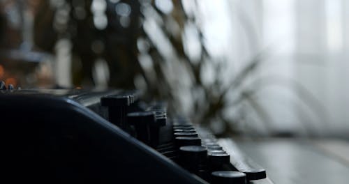 Close Up Shot of a Man Using a Type Writer