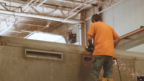 Man Sanding With Grinding Machine