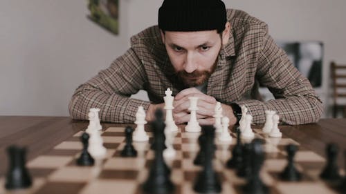 Man Looking at a Chessboard