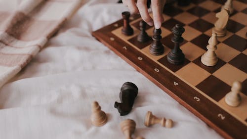 Close Up Shot of a Person Playing Chess