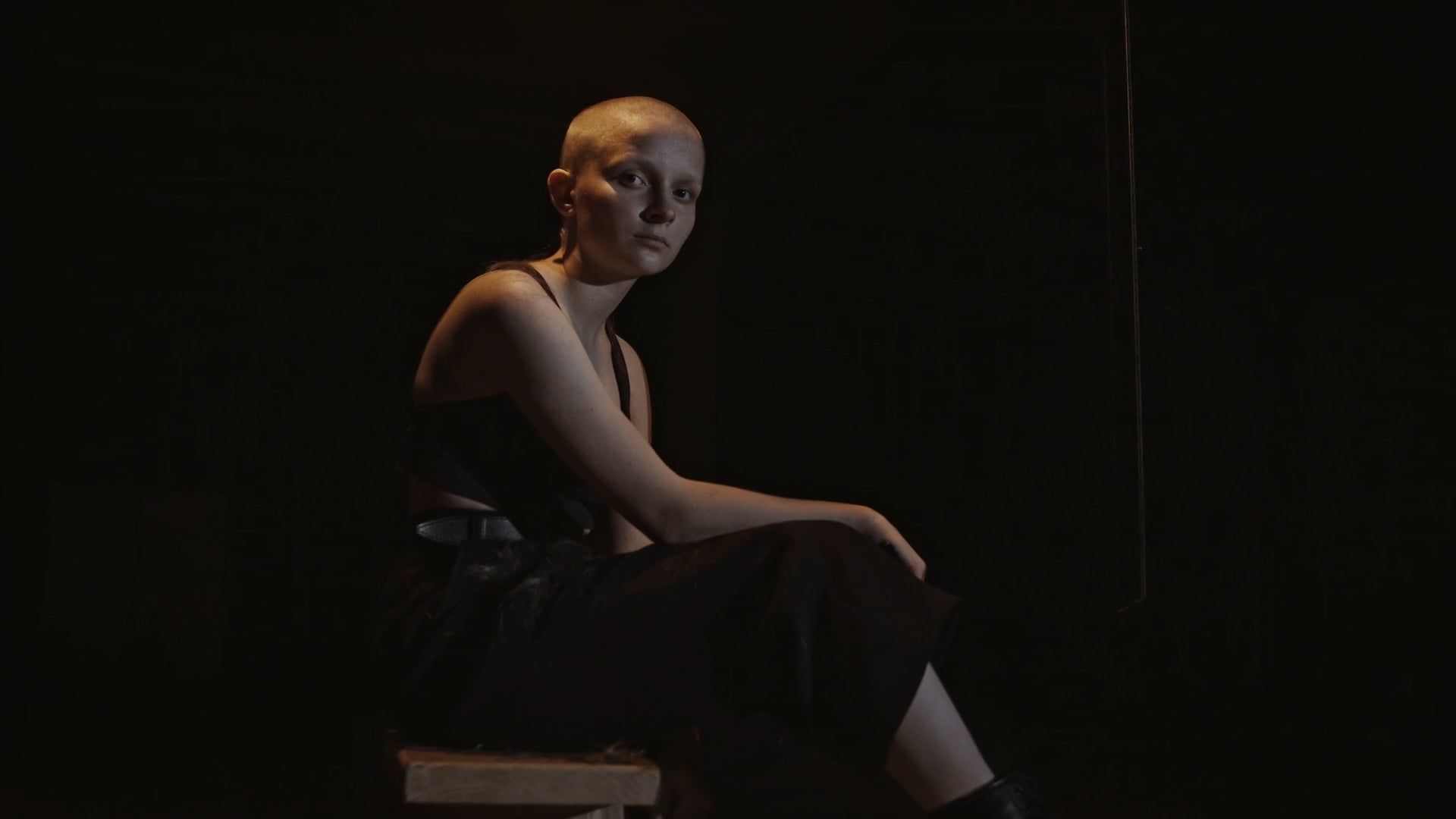 A Woman Sitting Alone in a Dark Room · Free Stock Video