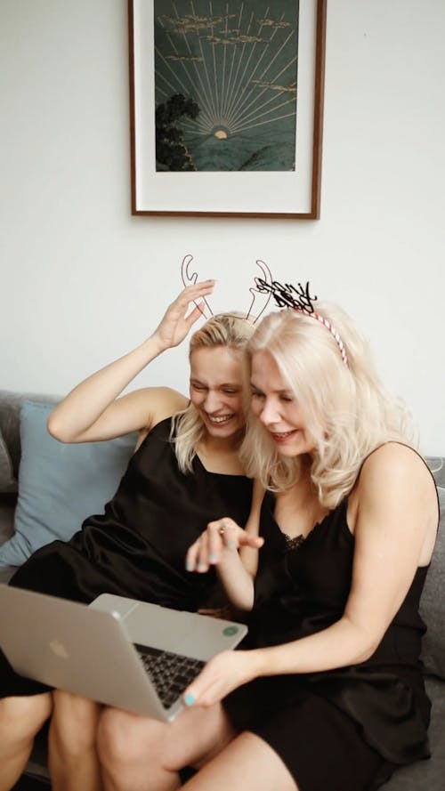 Mom And Daughter Laughing In A Video Call