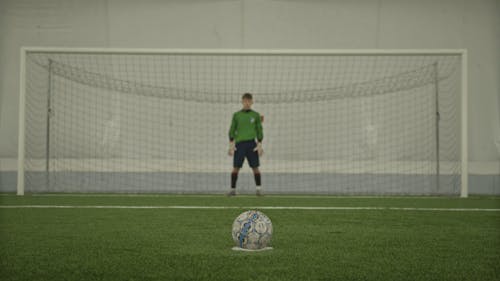 A Person Kicking a Football 