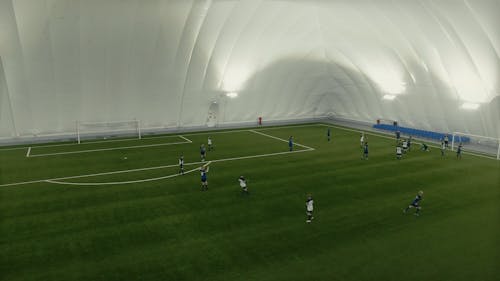 Aerial View of Football Team Training in Airdome