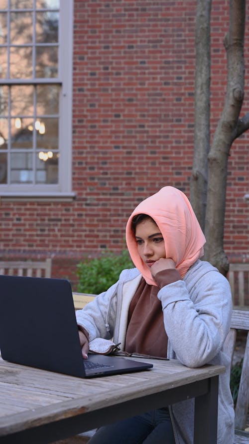 Woman Wearing Hijab Using a Laptop