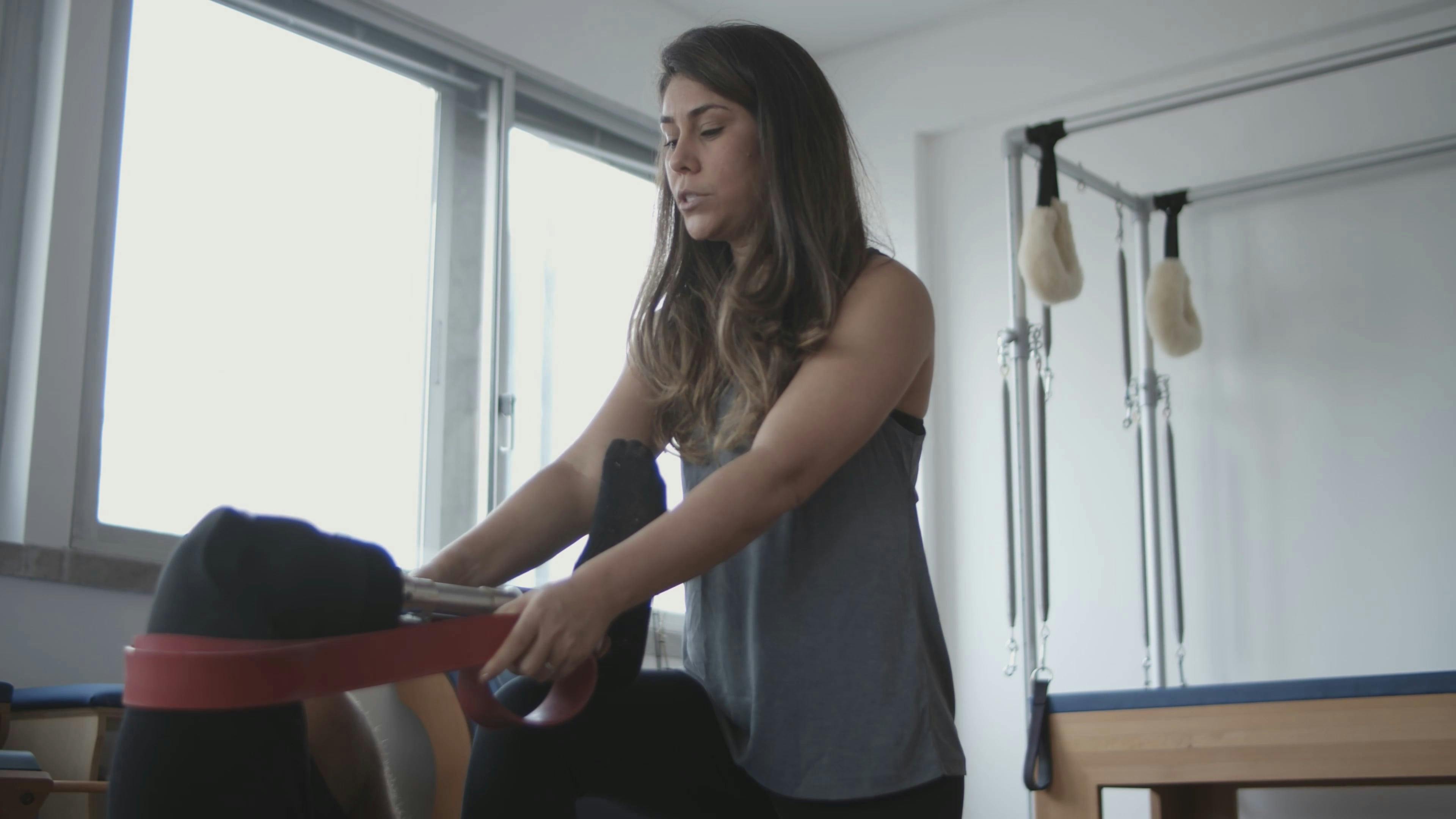 A Man Assisting A Woman In Using The Flat Pulldown Weights Equipment In ...
