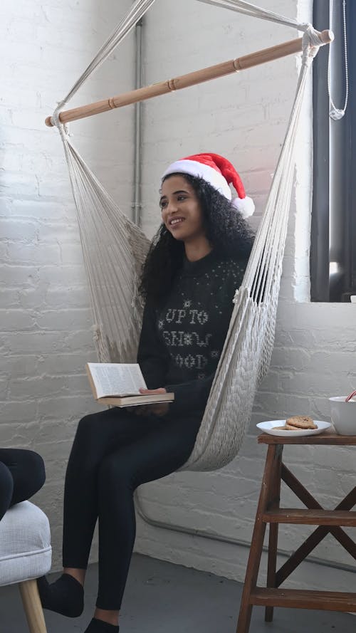 Woman with Santa Hat in a Hammock Chair