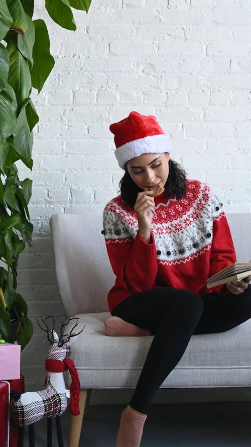 Seated Woman Reading and Eating a Cookie