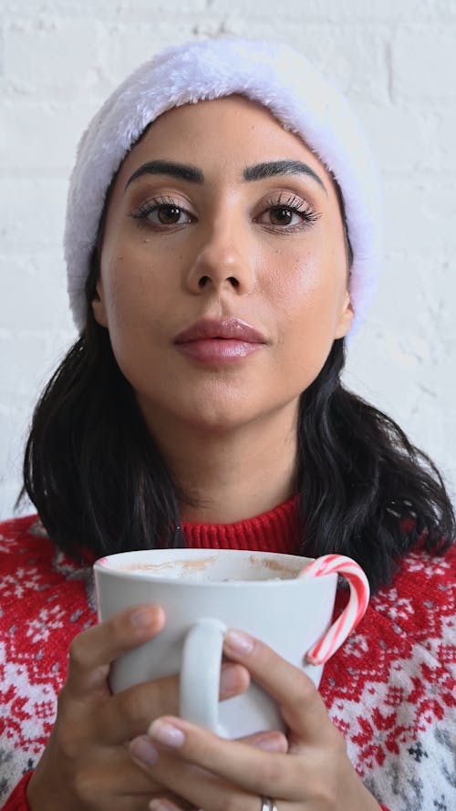 A Woman Posing While Holding a Teacup
