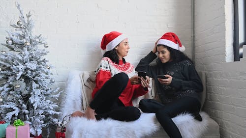 Women Dressed In Christmas Costume While Talking