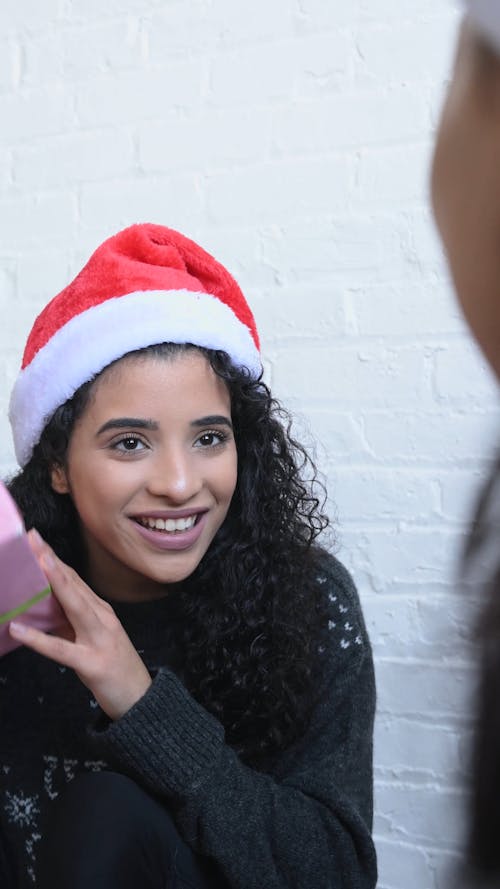 Young Woman Opening a Christmas Gift