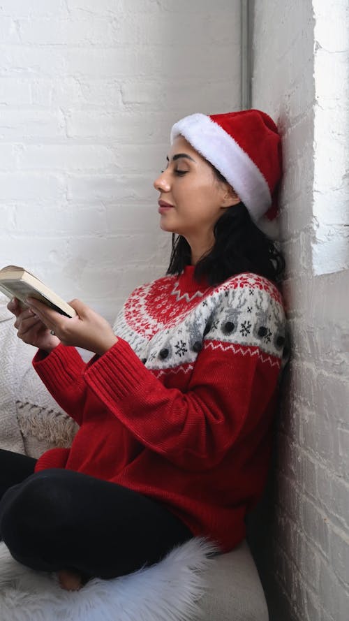 Adult on Christmas Clothes Reading a Book
