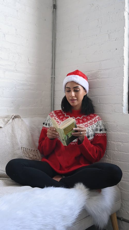 Girl on Christmas Clothing Reading on the Sofa