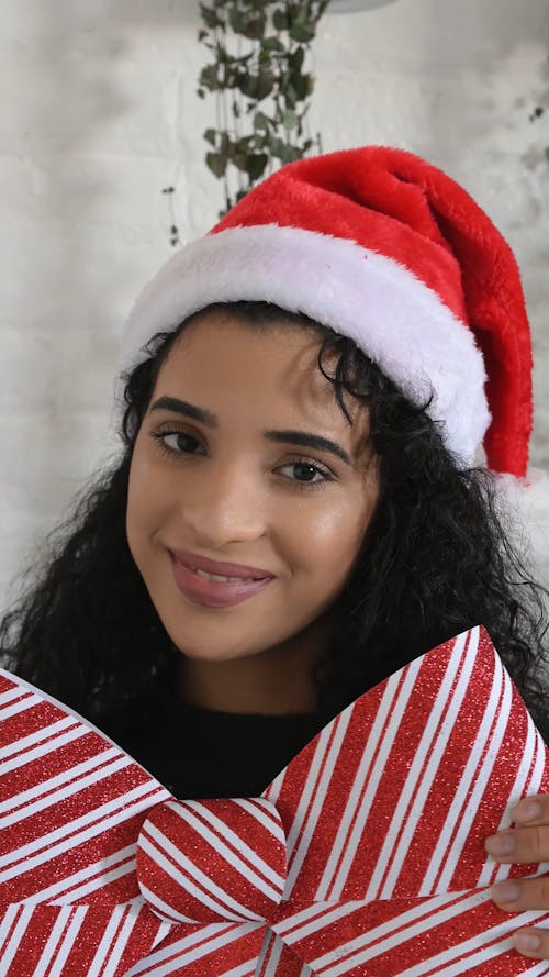 Portrait of Young Person Holding Christmas Decor