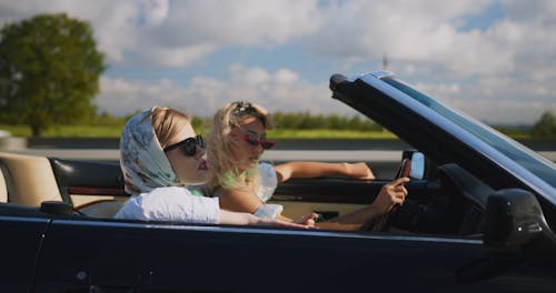 Two Women Riding a Car