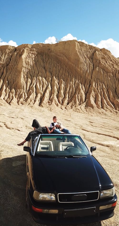 Models Posing on a Convertible