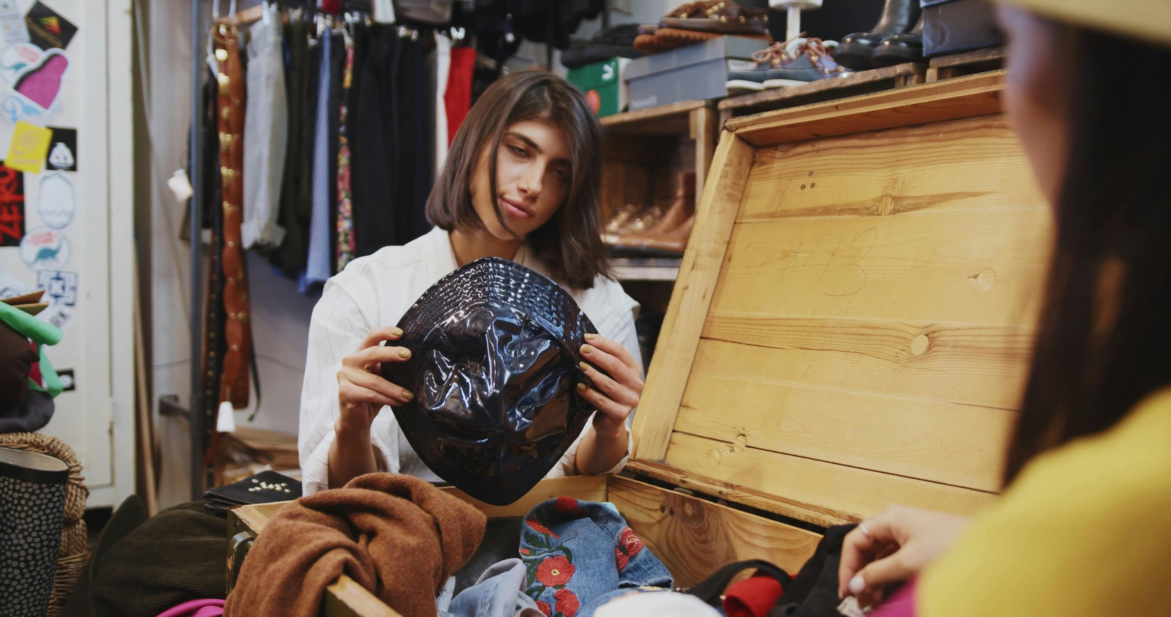 Girl Trying a Bright Hat in a Thrift Shop &middot; Free Stock Video
