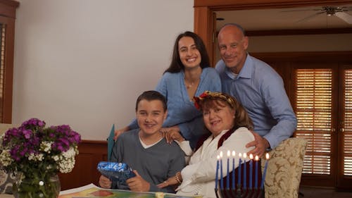 Family Taking Group Photo During Hanukkah