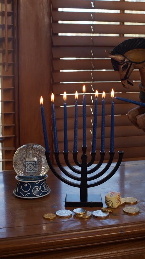 A Candelabrum With Blue Candles And Crystal Ball Decorations On Table