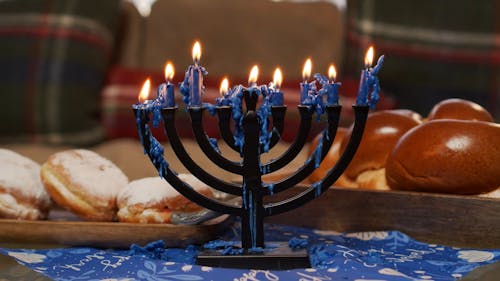 Challah Bread And Menorah With Blue Candles