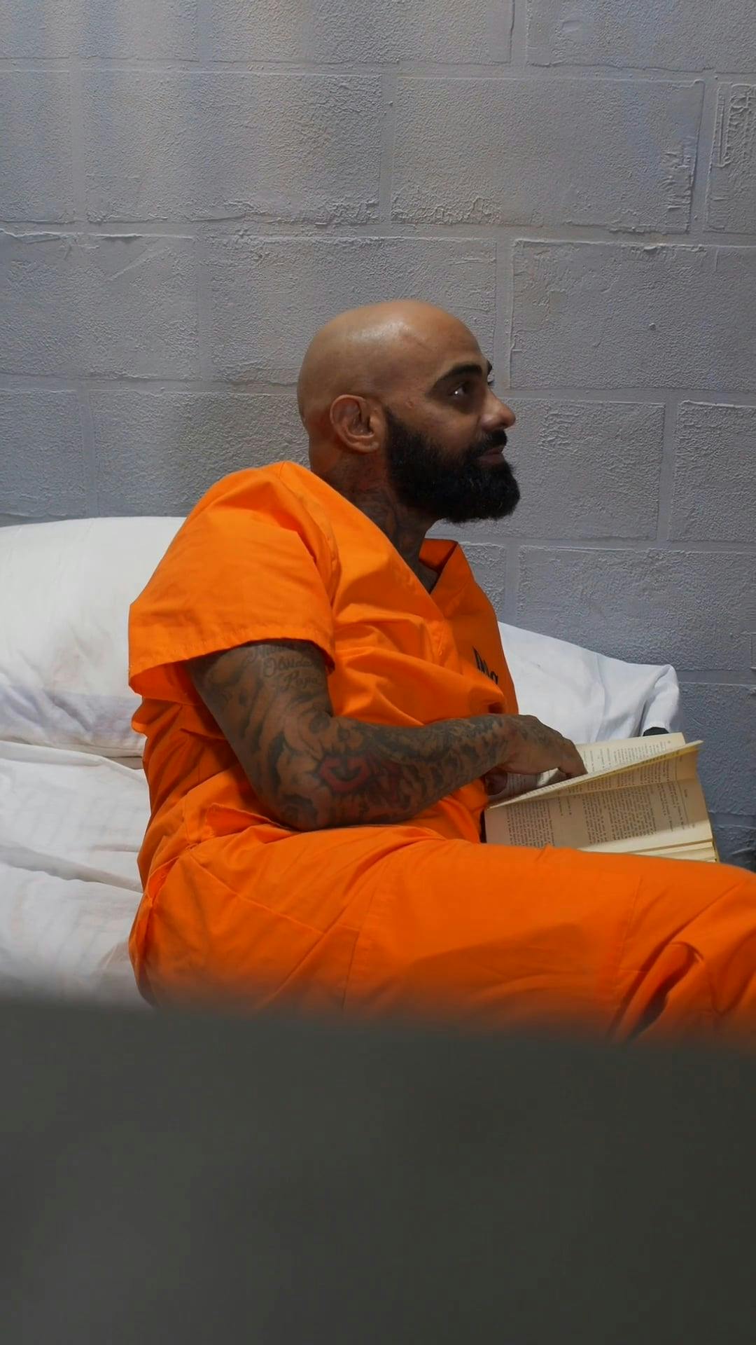 Tattooed Inmate Holding a Photo · Free Stock Video