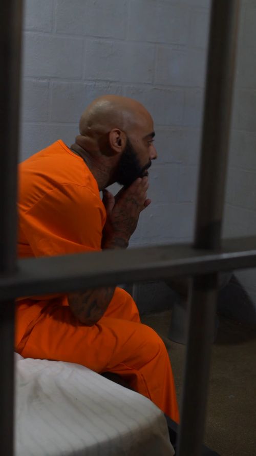 Bearded Inmate Two Male Convicts Talking while Sitting in the Prison Yard · Free Stock ...