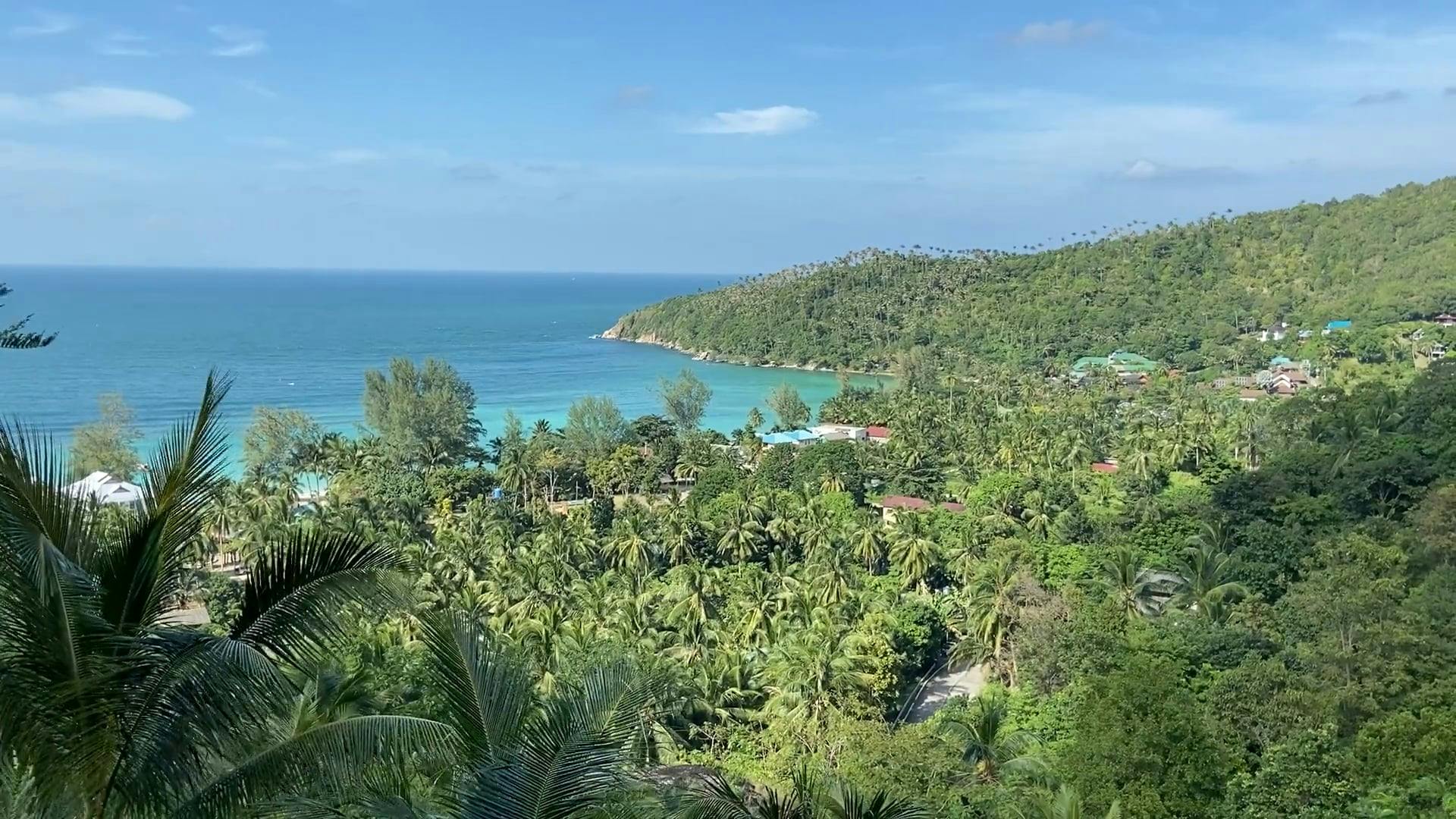 Low Angle Footage Of Cottages Along The Shoreline Of Of A Tropical