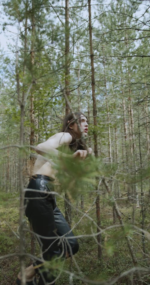 Shirtless Man Walking in the Forest