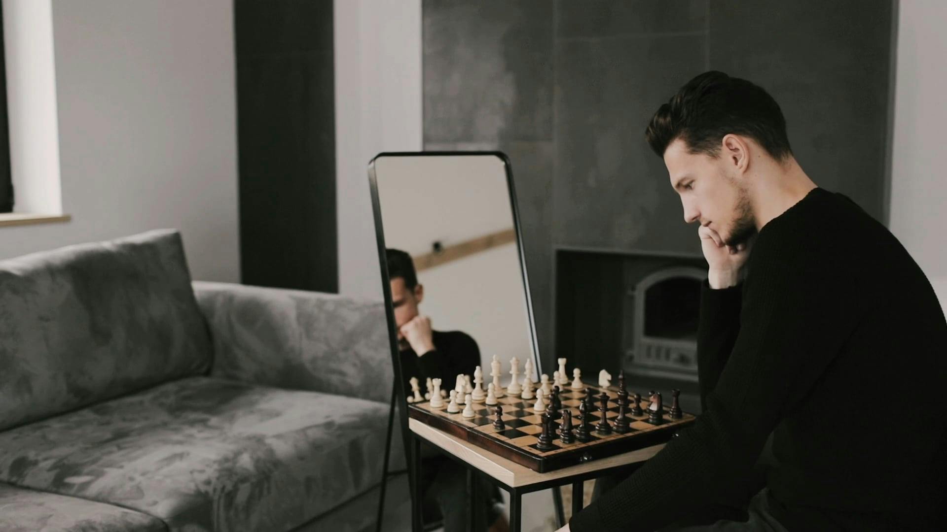 A Man Playing Chess Alone in Front of a Mirror Free Stock Video Footage