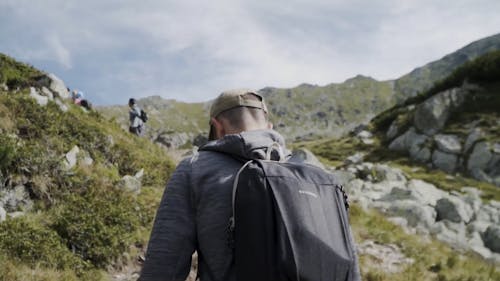 Men Hiking and Talking on a Walkie Talkie