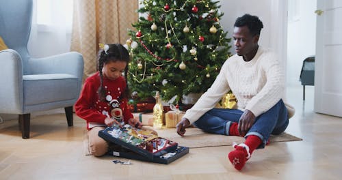 Dad and Daughter Playing an Advent Calendar Game