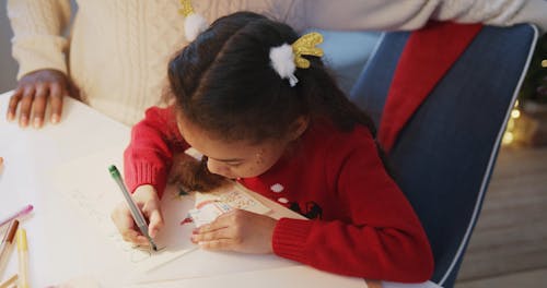 A Father Watches Her Daughter Makes A Letter To Santa Claus