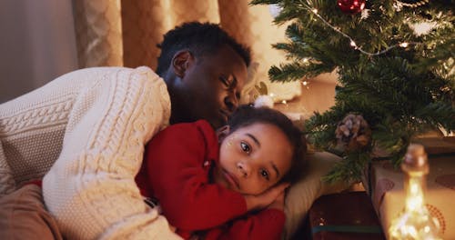 A Girl Waking Up and Put a Christmas Gift Near a Christmas Tree