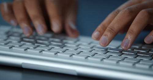 Hands Typing on a Keyboard