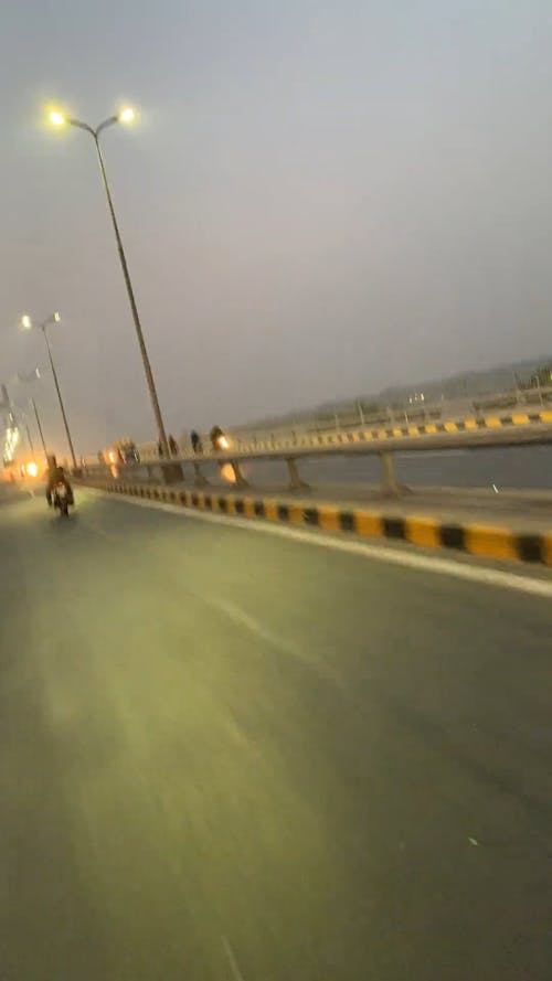 Time Lapse of A Vehicle Passing a Suspension Bridge