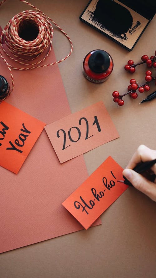 Person Writing on a Piece of Paper